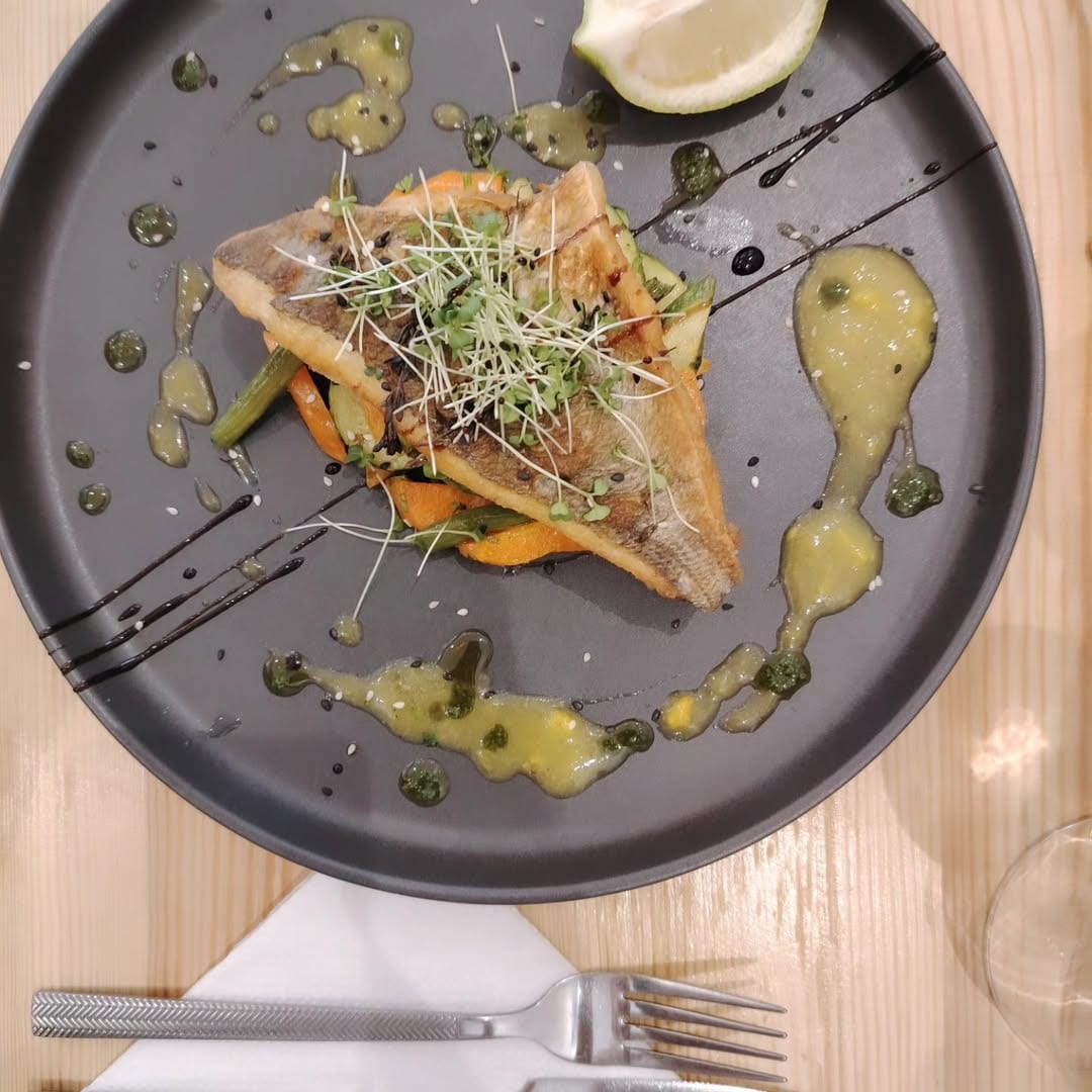 Sea bass plated with microgreens and citrus at Butterfly Space, Essaouira